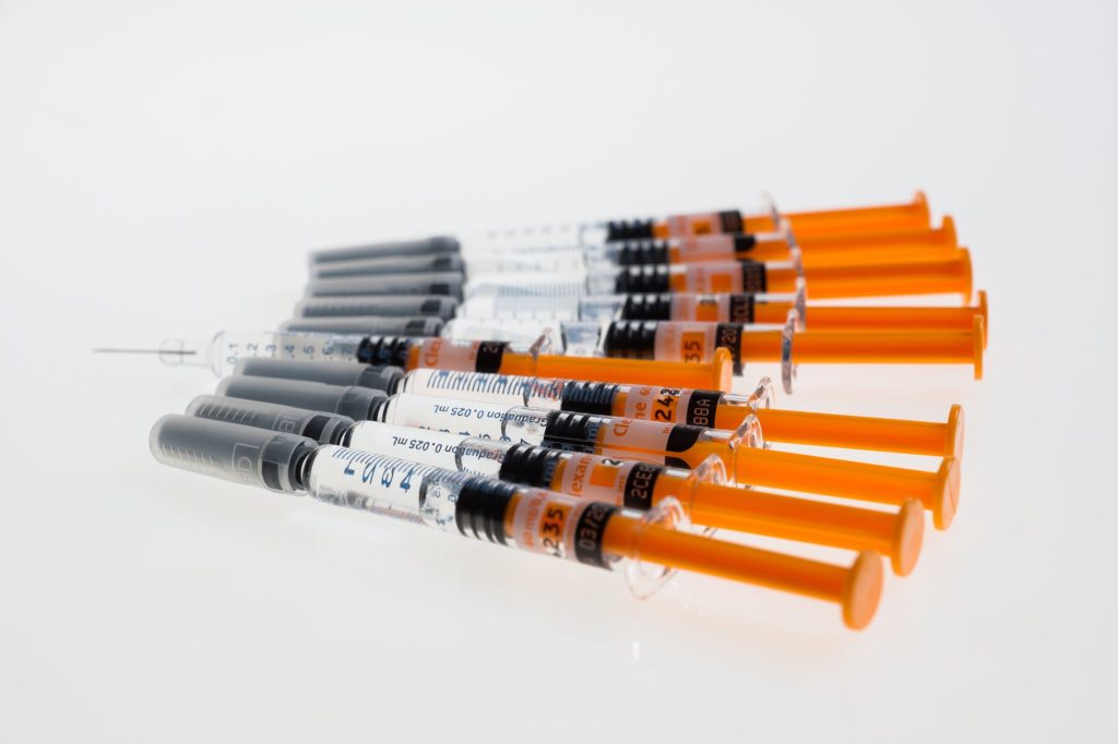 multiple syringes with orange plungers