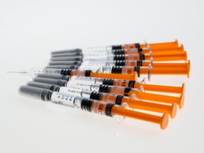 multiple syringes with orange plungers