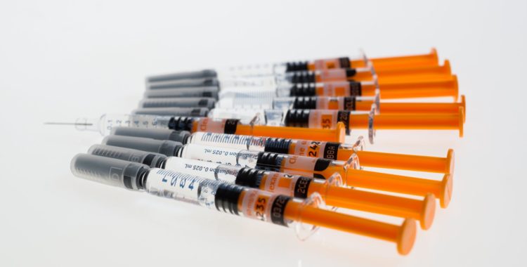 multiple syringes with orange plungers