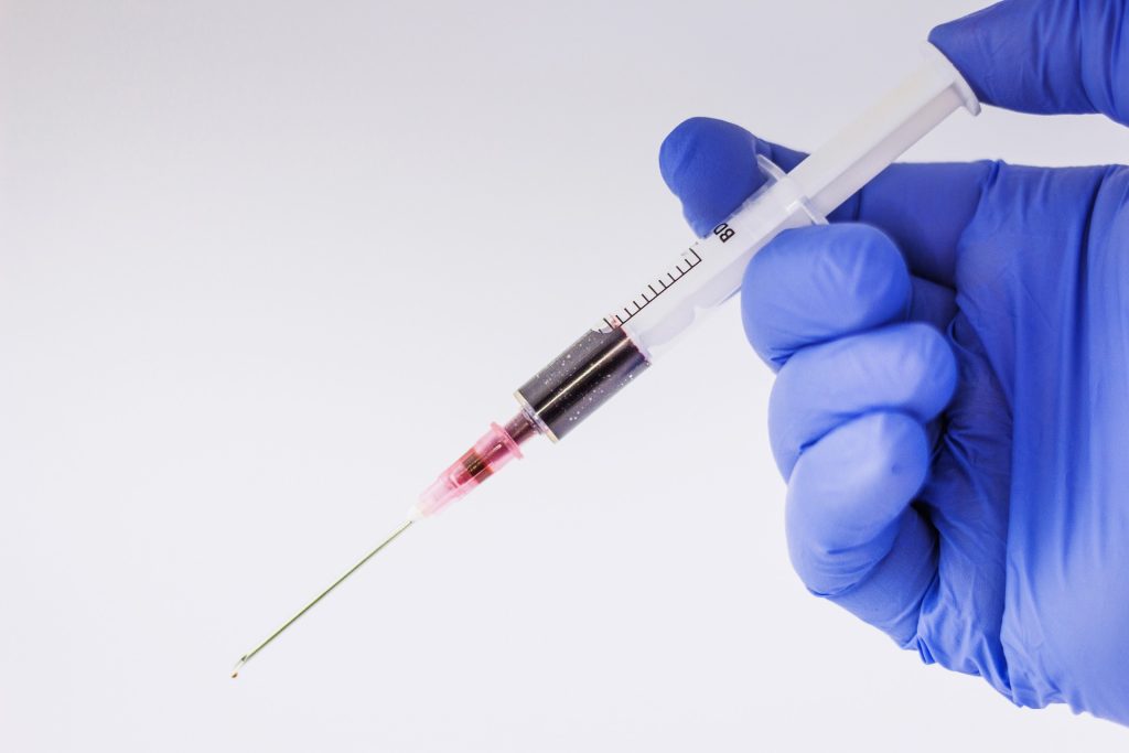 glove holding syringe