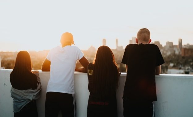 Four youngsters standing in a balcony