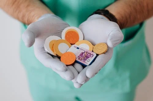 coins in a doctor’s hand