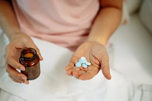 pills in a person’s hand
