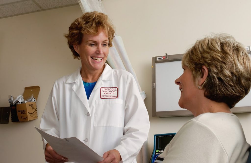 A female doctor talking to a patient.