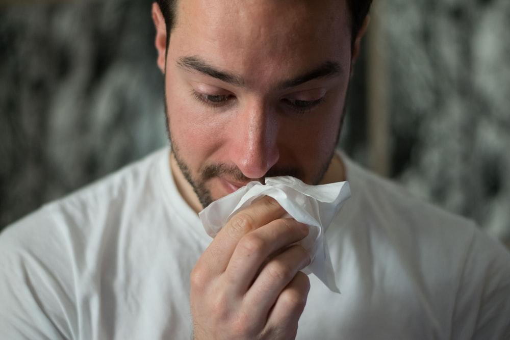 A man wiping his nose