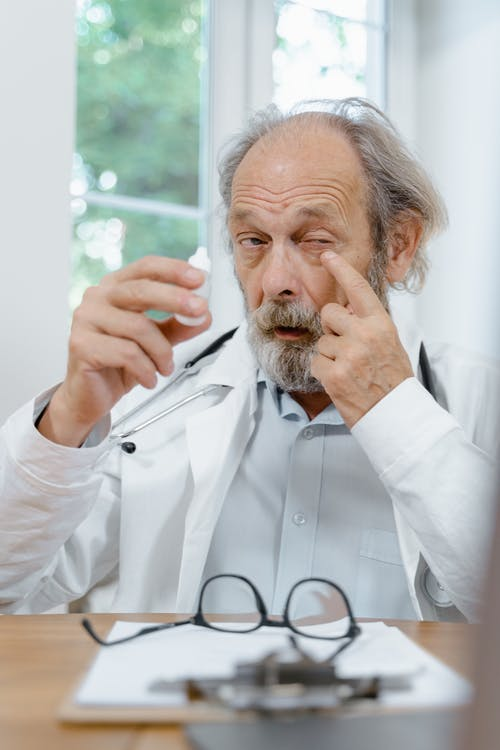a doctor applying eye medicine