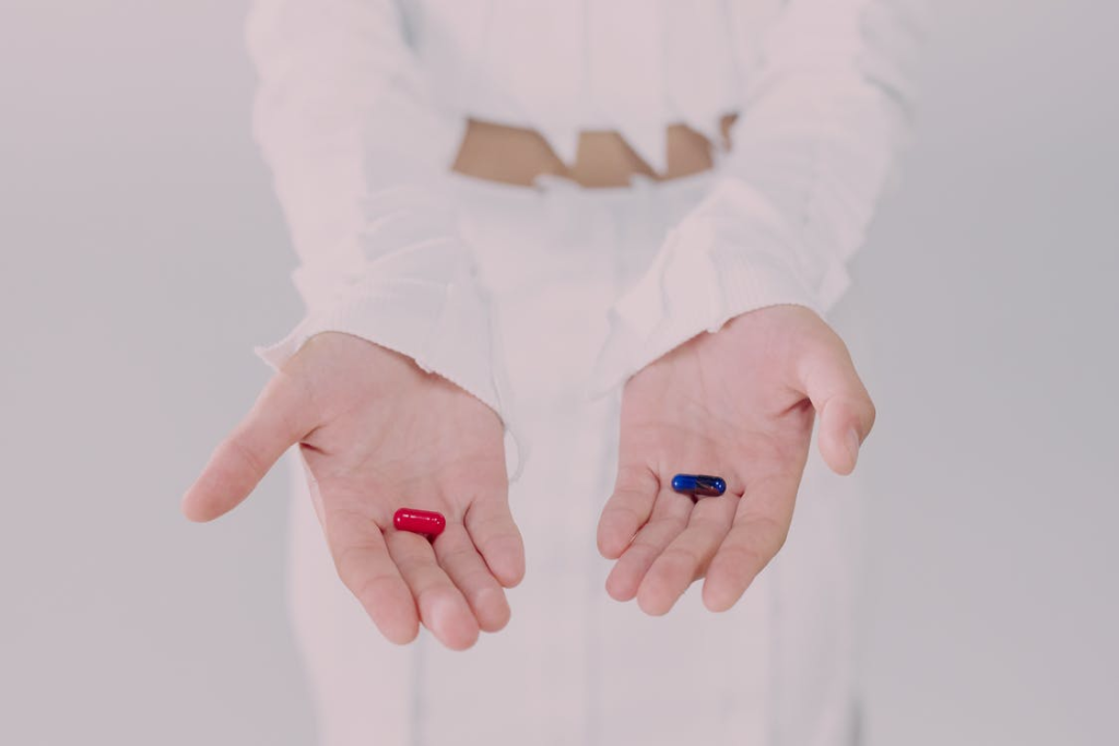 a person holding capsules in each hand