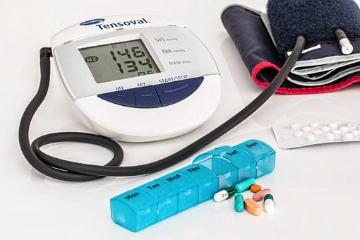 a blood pressure measuring machine and medicines on a table