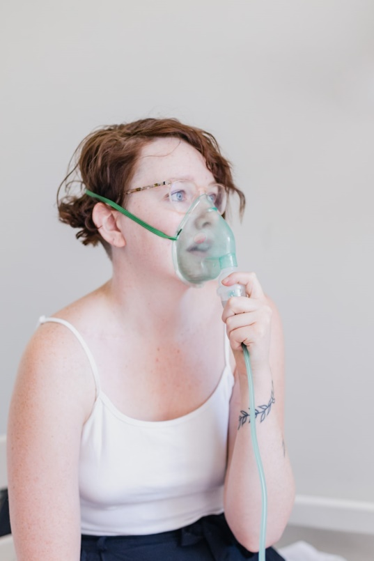  a woman using a nebulizer