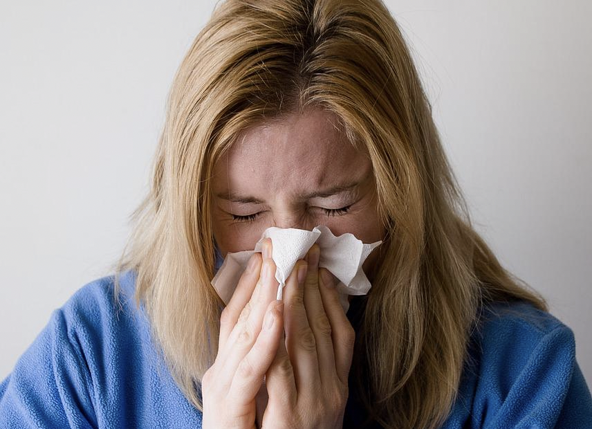 Woman exhibiting flu-like symptoms