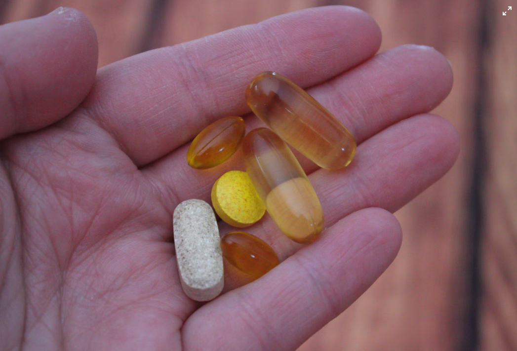 a person holding medicines in their hand