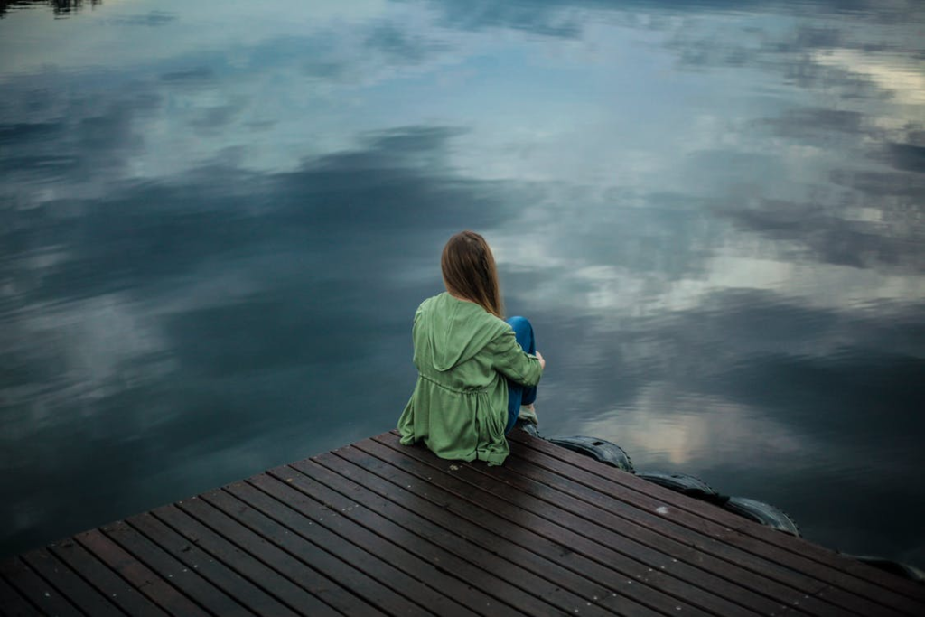 A woman sitting on wooden planks