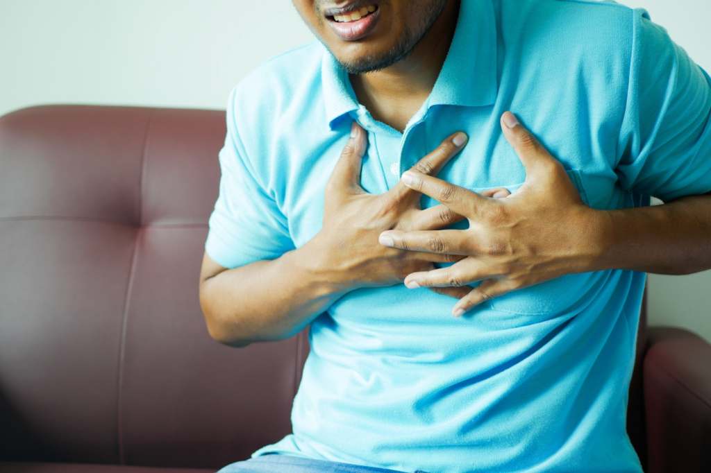 person in discomfort, with hands-on chest