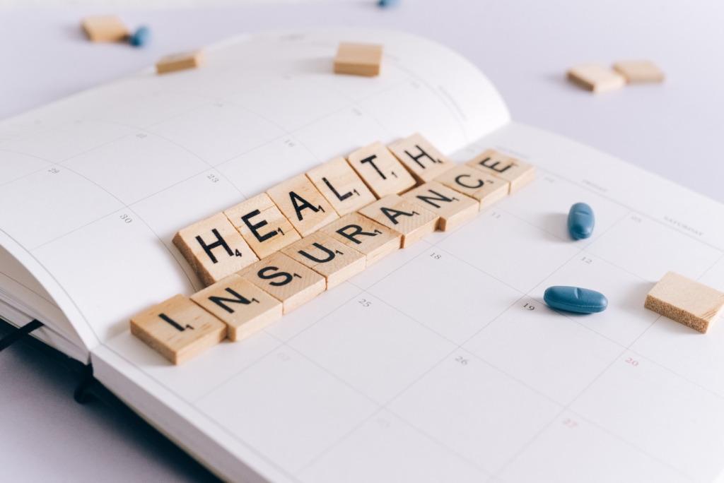 Health insurance scrabble tiles on a planner