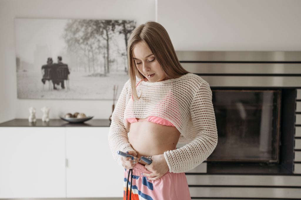 woman in pink top injecting novolog insulin