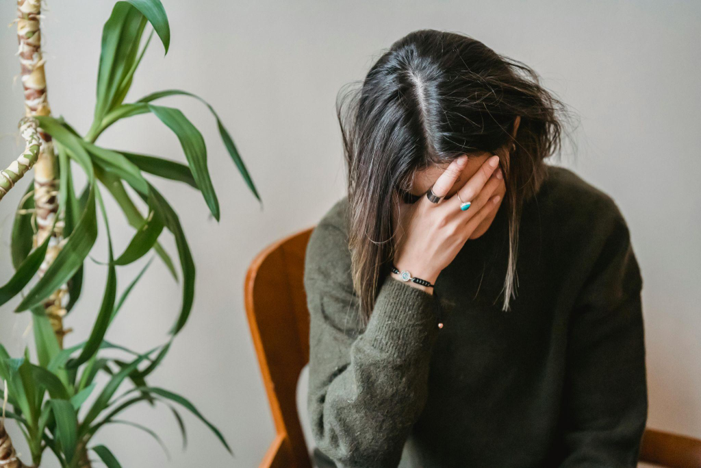 a person holding their face