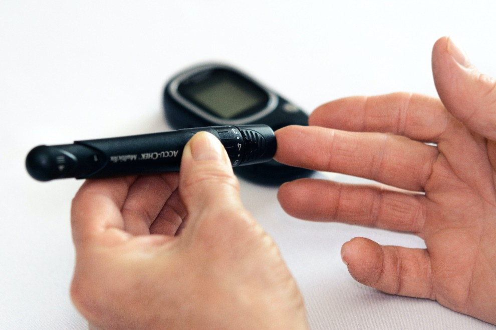 Person holding a glucometer