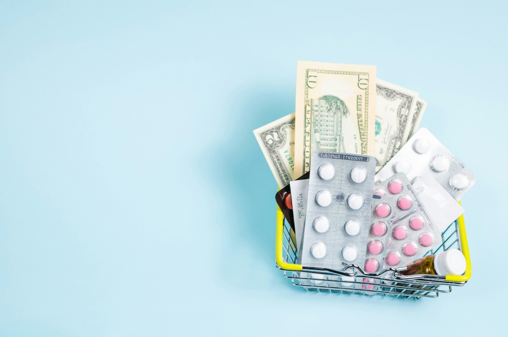medicine tabs and US dollar bills in a small metal basket