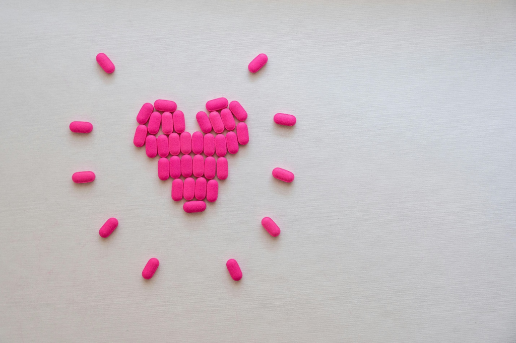 pink pills arranged in a heart shape