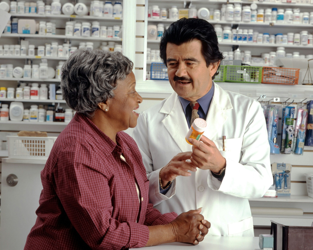 a pharmacist giving medication to a woman