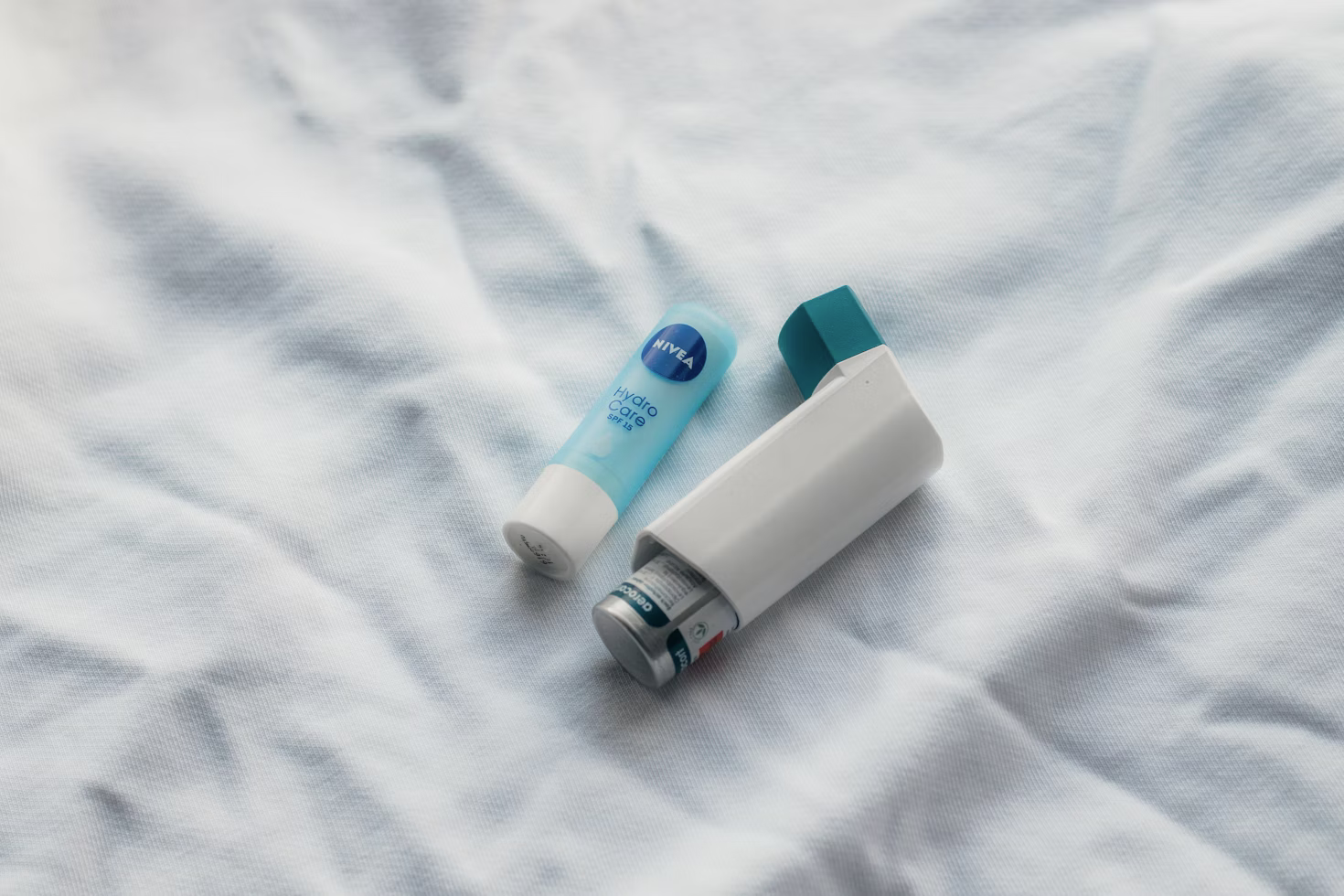 An asthma inhaler and medication on a table