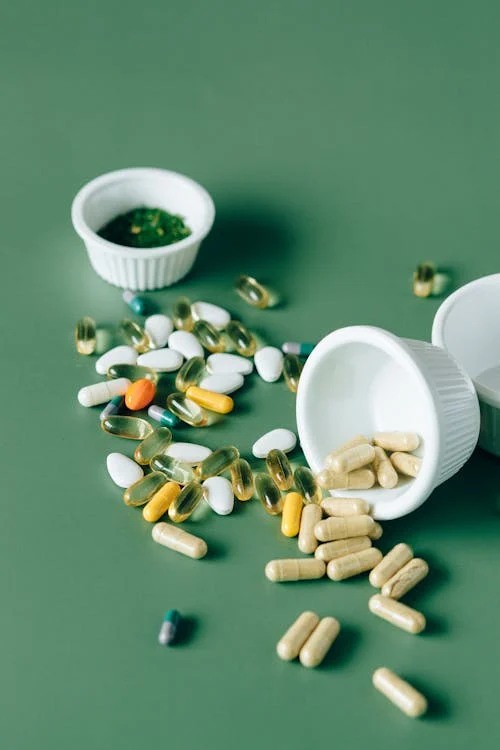 A stack of heart disease medication bottles on a table