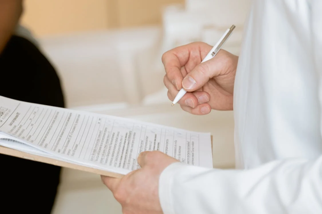 A patient reviewing paperwork with a doctor