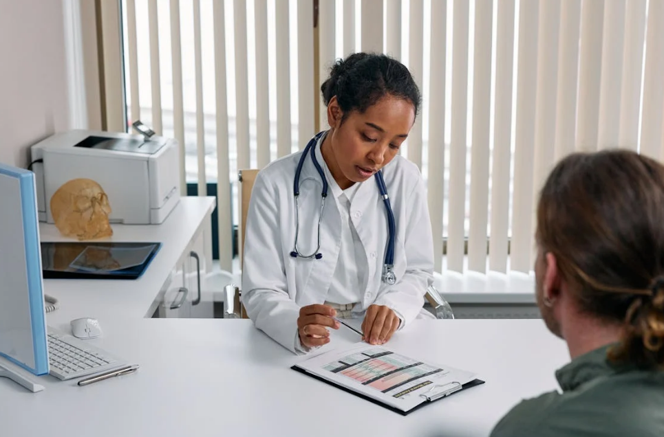 Doctor reviewing a patient's prescription assistance application during a consultation