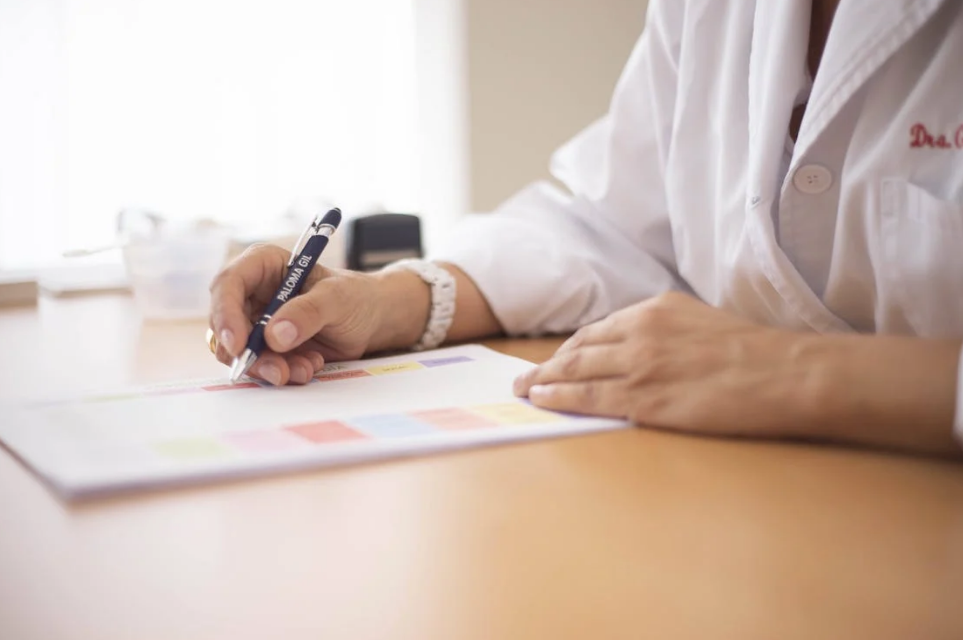 Doctor filling out a prescription assistance application form