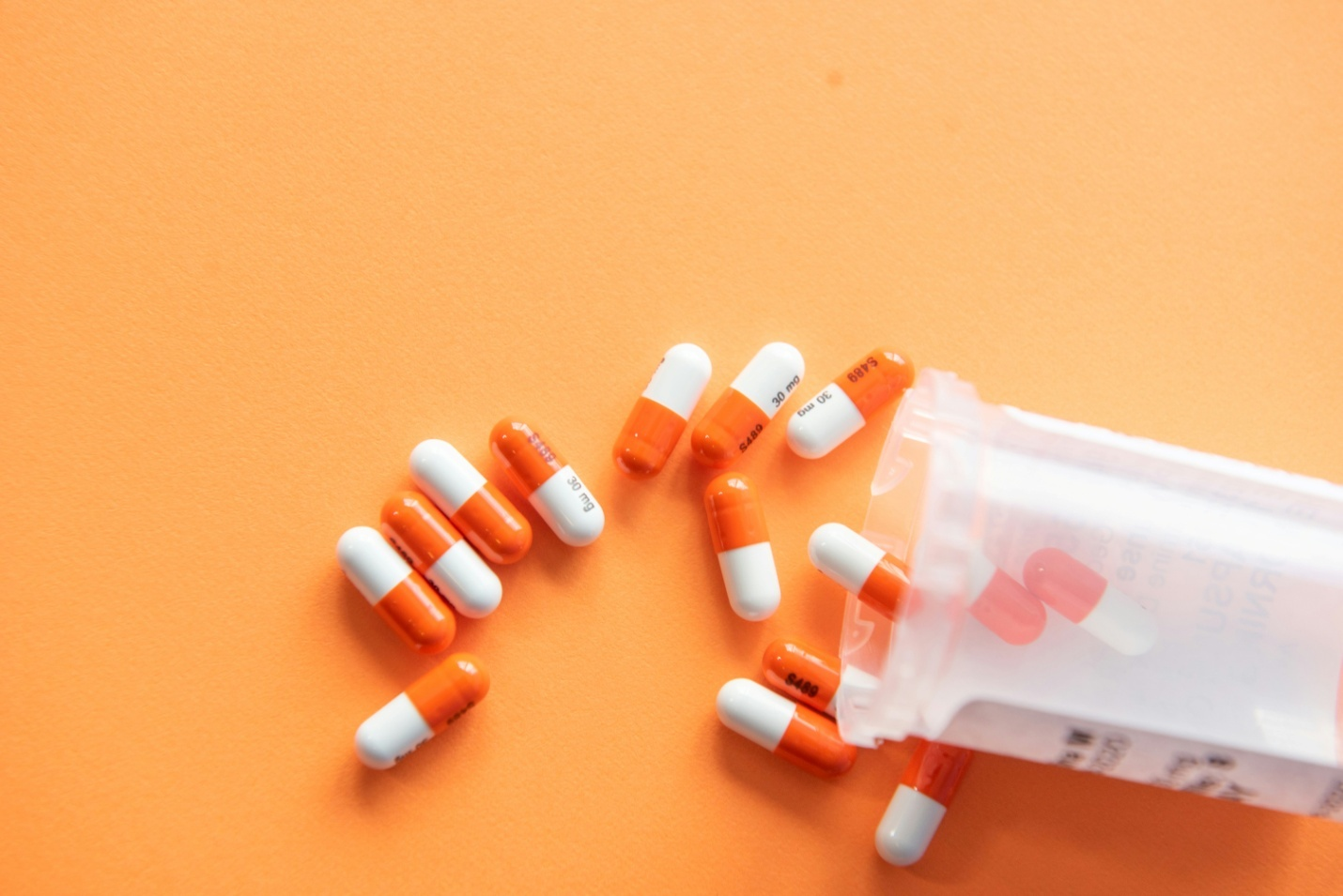 medicines spilling onto a surface from a bottle