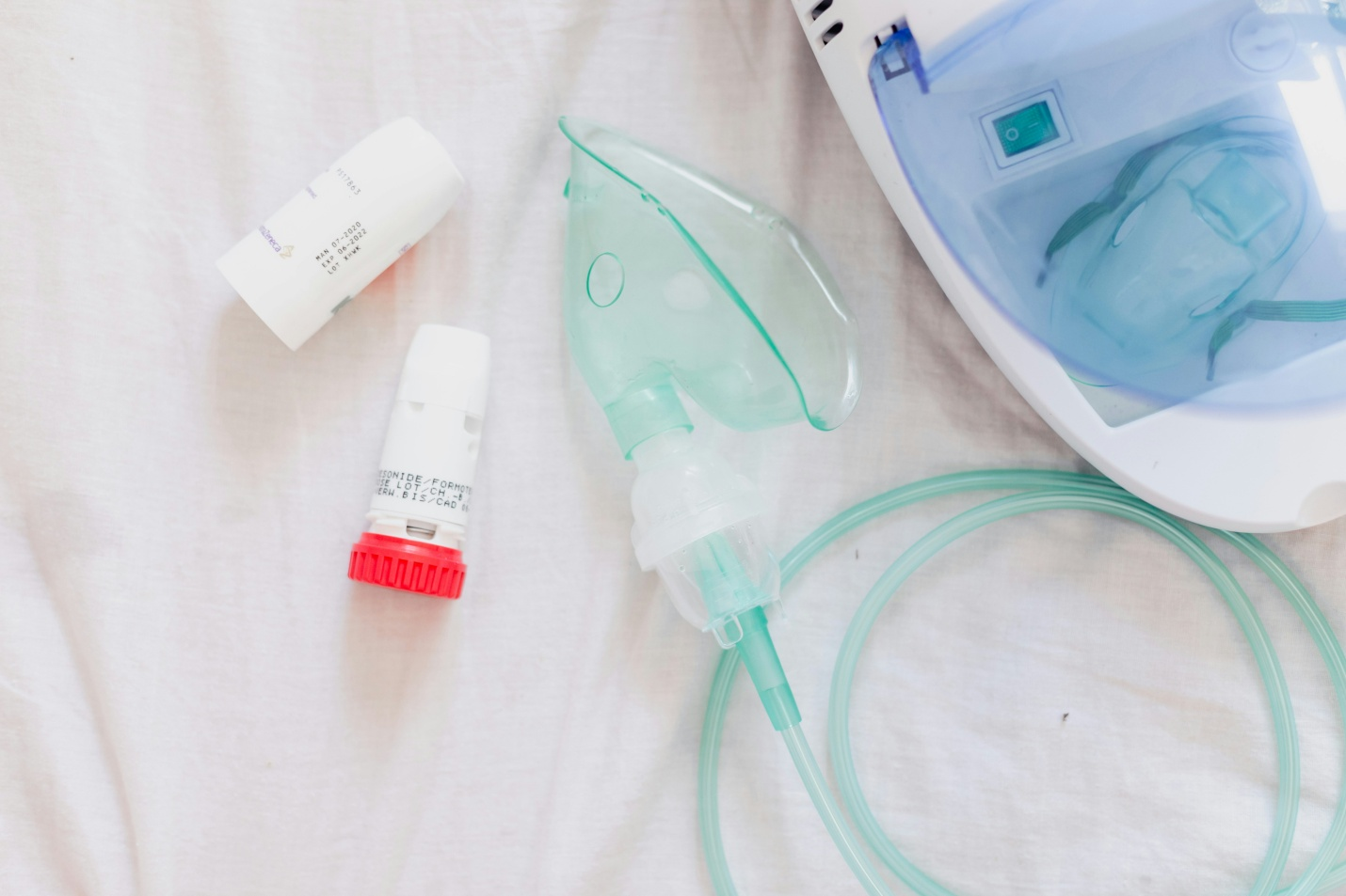 IV tubes and mask lying on a white sheet