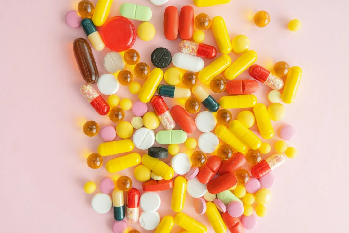 Various medicines on a pink surface 