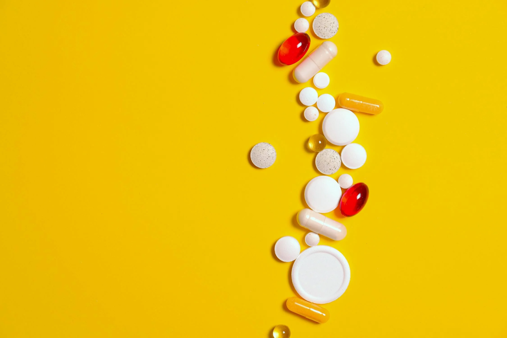 a row of various medicines on a yellow background