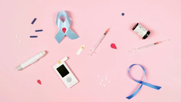 various diabetes supplies, including syringes, test strips, and a glucose meter.
