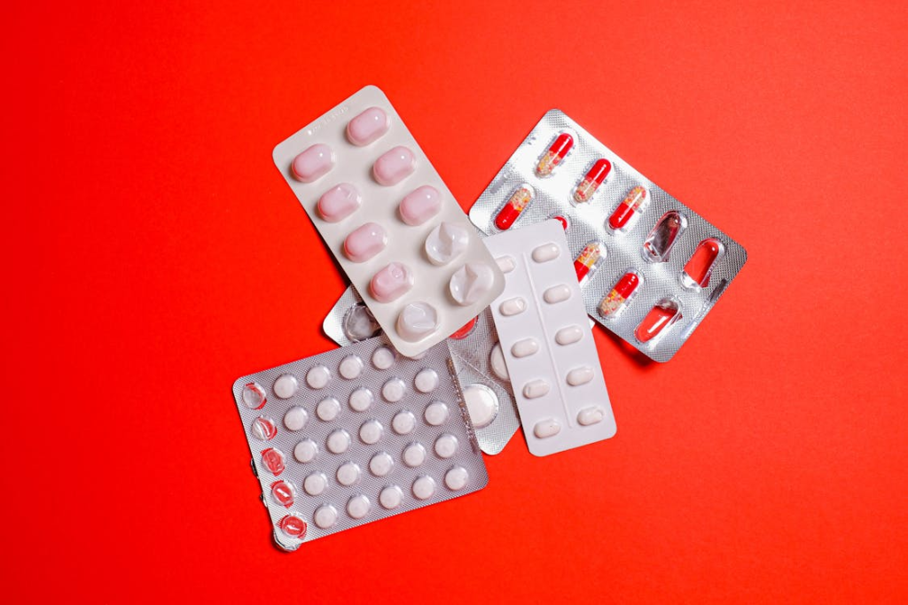 Medicine blister packs on a red surface
