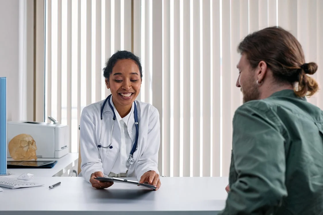 Doctor showing clipboard to patient