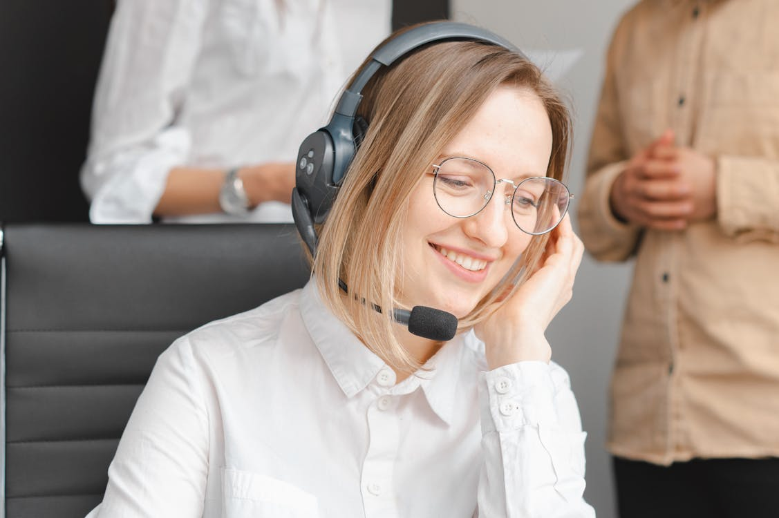 A compassionate support agent speaking on the phone with a patient