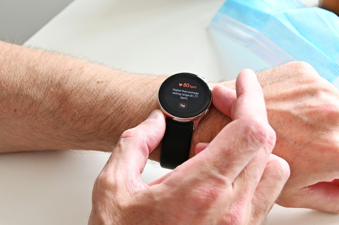 close-up of hands with a heartbeat monitor on it