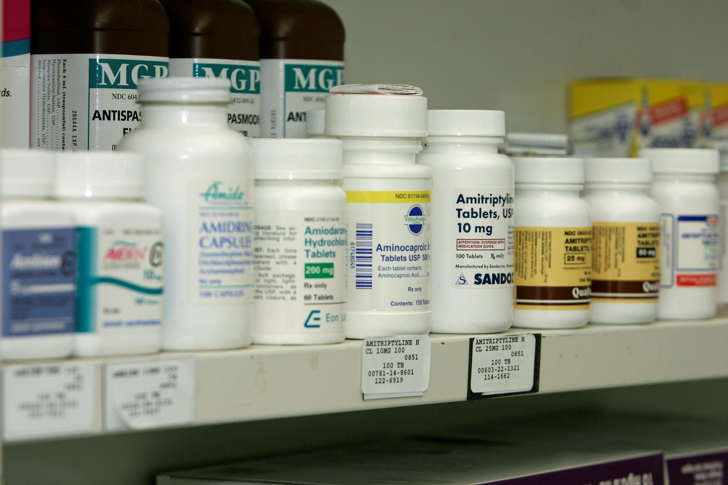 A large drug store with several bottles of drugs lined up together.