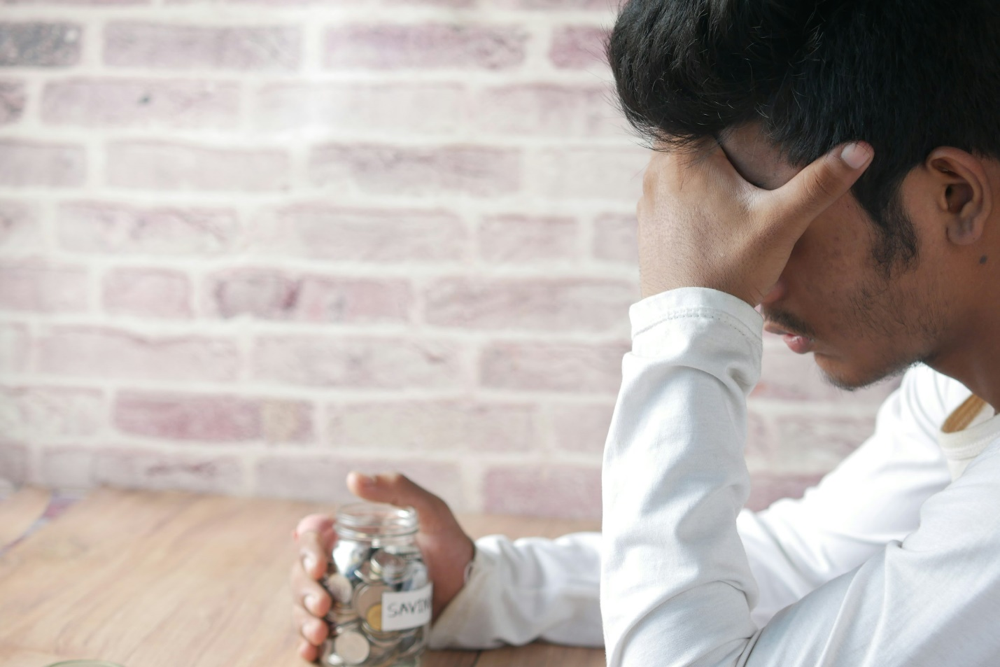 A person having migraine and sitting randomly at a table.
