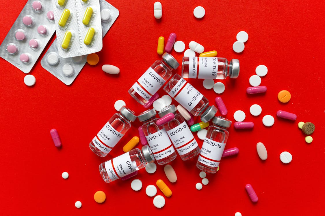 A red colored platform with medicine laid out all over it.