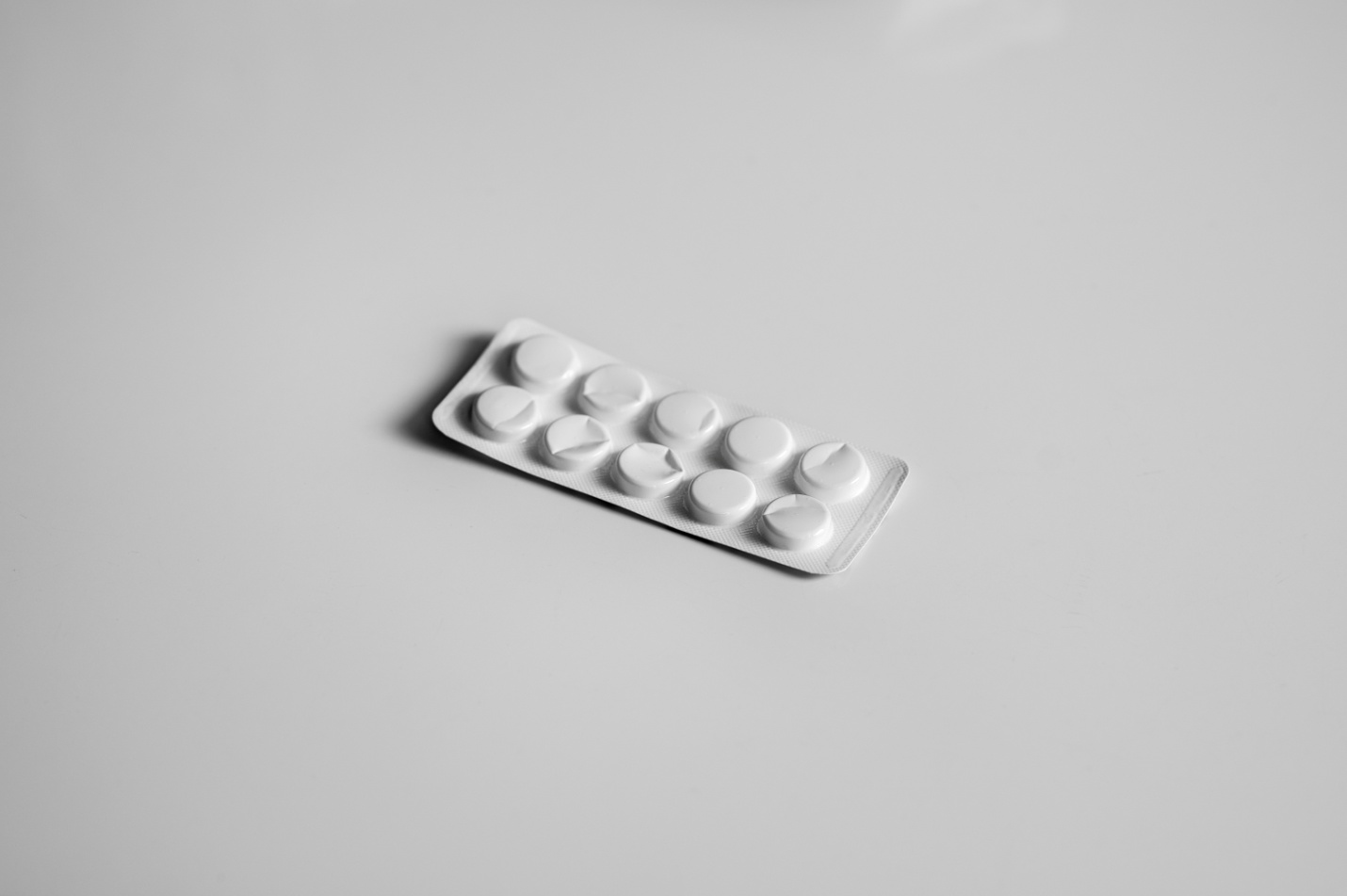 white blister pack of medicine on a white surface