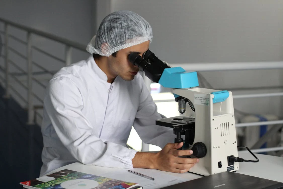 A medical professional working on a microscopic machine.