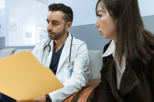 Woman discussing medication options with her doctor