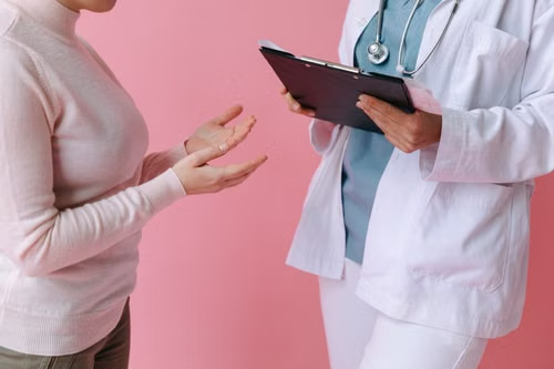 Patient discussing medication costs and assistance options with a doctor