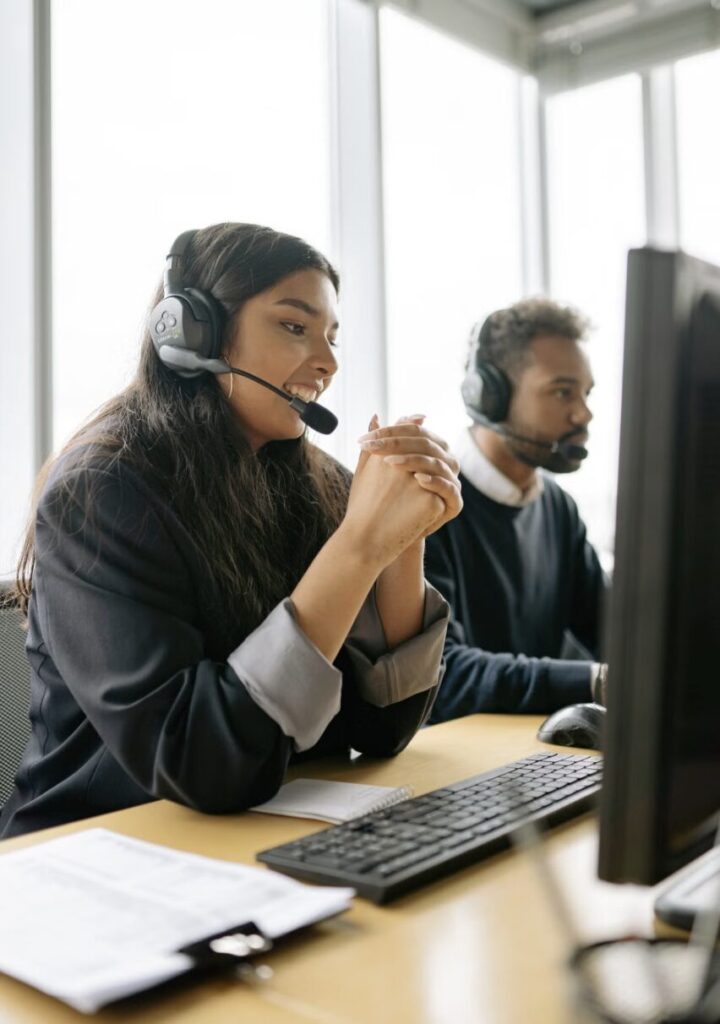 This photo shows a customer service representative assisting a patient over the phone.