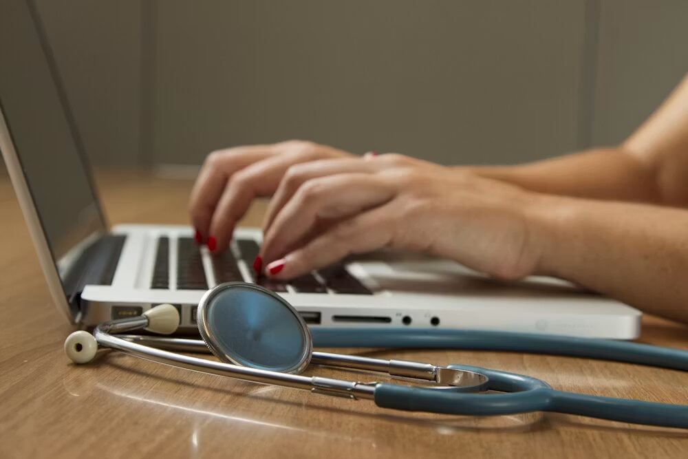  A stethoscope next to a laptop