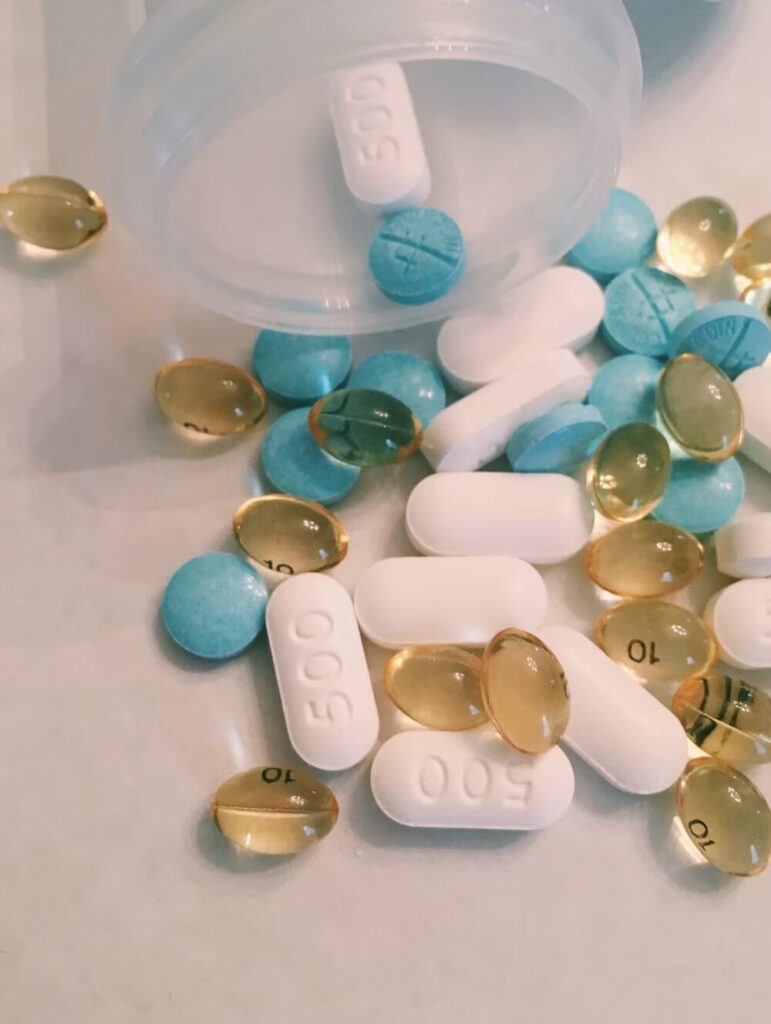 Pills falling out of a bottle