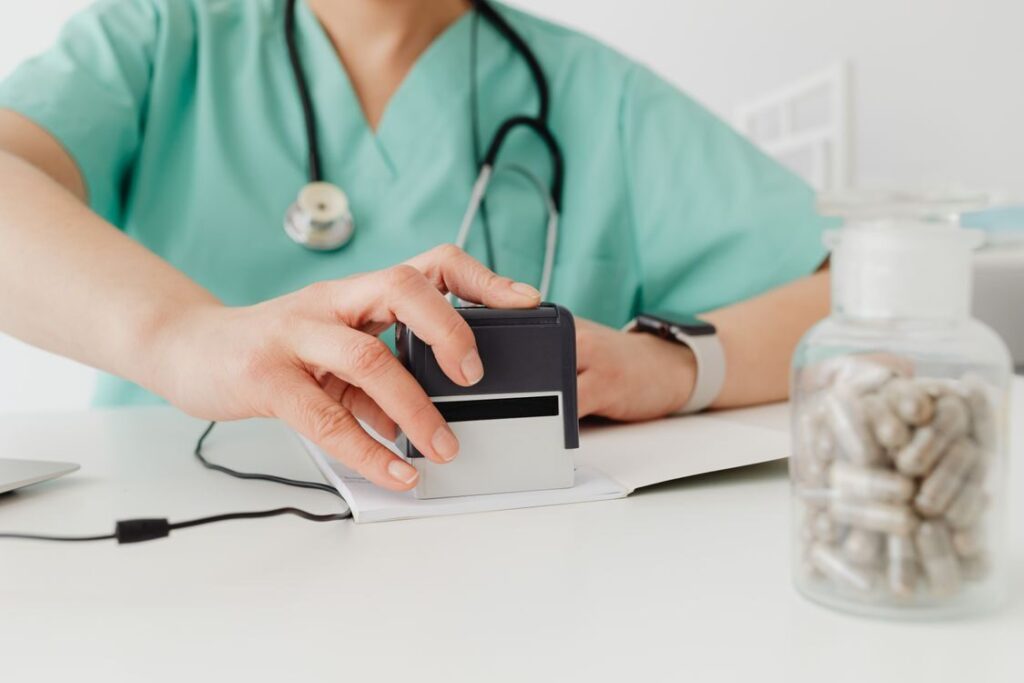 An image of a doctor stamping a prescription