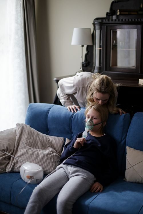  An image of a mother nebulizing a child